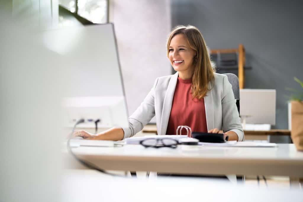 Tax professional working at her desk in an office setting.
