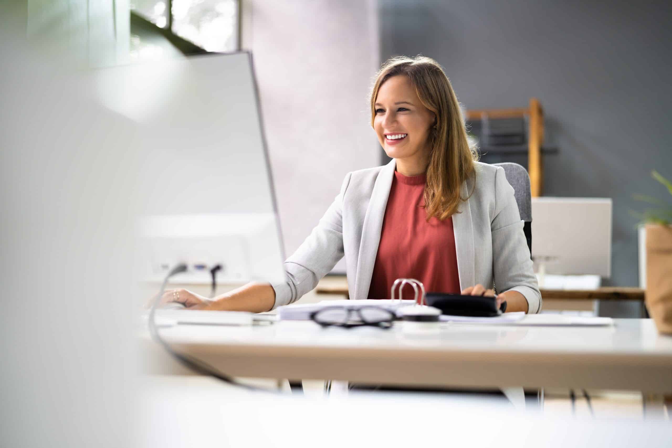 Tax professional working at her desk in an office setting.
